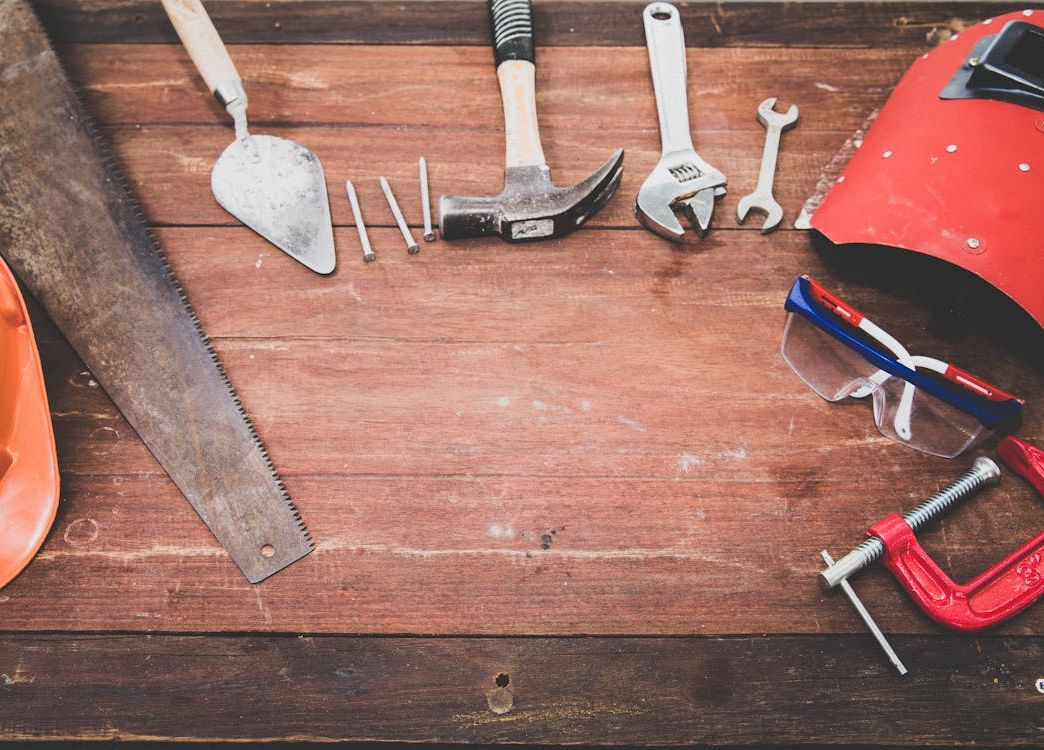 flat lay of safety tools and equipment on wooden table